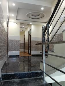 a lobby of a building with stairs and a ceiling at Govind Anand Dham in Vrindāvan +1 photo