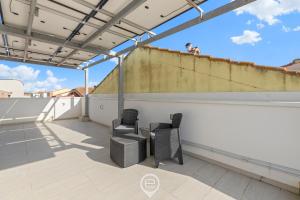 two chairs on the roof of a building at ArchiHouse Seafront in Torre Grande