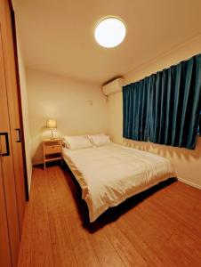 Ένα ή περισσότερα κρεβάτια σε δωμάτιο στο 池袋本町201