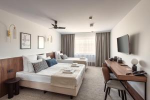 a living room with a couch and a table at AIRINN Vilnius Airport Hotel RENOVATED 2025 in Vilnius