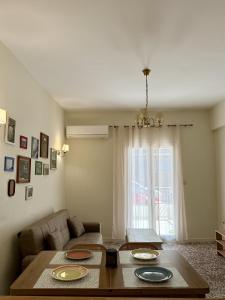 a living room with a table and a couch at Anefos apartment in Ágios Rókkos +10 photos