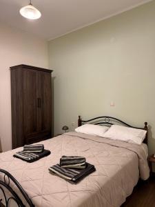 a bedroom with a bed with two towels on it at Anefos apartment in Ágios Rókkos