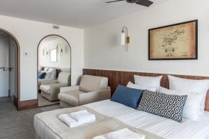 a bedroom with a bed and a living room at AIRINN Vilnius Airport Hotel RENOVATED 2025 in Vilnius
