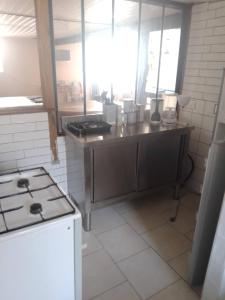 a kitchen with a stove and a counter top at Studio calme avec billard in Saint-Priest +1 photo