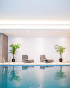 a hotel lobby with a swimming pool at Orchardz Jayakarta in Jakarta