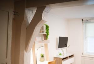 a living room with a staircase and a tv at Altbautraum Esslingen Zentrum Studio 09 in Esslingen