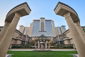 a view of a building with tall buildings in the background at The Azure Ningbo, Vignette Collection by IHG in Ningbo