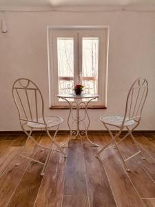 two chairs and a table in a room with a window at Locazione turistica Cascina Pela in Castagnole Lanze +36 photos