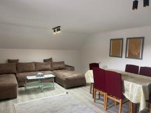 a living room with a couch and a table at Casa Albă in Vatra Moldoviţei