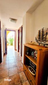 a room with a wooden cabinet with a ship on it at SIM01 Direct Access to Pool Area Las Lomas in Ayamonte