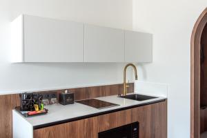 a kitchen with a sink and a counter top at AIRINN Vilnius Airport Hotel RENOVATED 2025 in Vilnius
