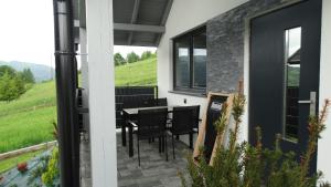 a view of a patio with a table and chairs at DOMINO-domek 5 in Krościenko