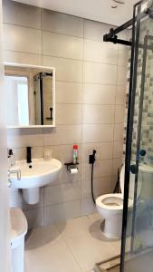 a bathroom with a sink and a toilet at Ground floor apartment,facing swimming pool, wifi , air conditioner in Martil