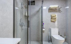a bathroom with a shower and a toilet and a sink at Panorama Suites in Nairobi with Swimmingpool,Wifi in Nairobi +15 photos