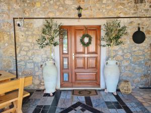 two large white vases sitting in front of a door at Ferienhaus Villa Marein in Poreč