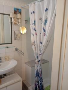 a bathroom with a shower curtain and a sink at Small Luxury Bed & Breakfast in La Spezia +7 photos