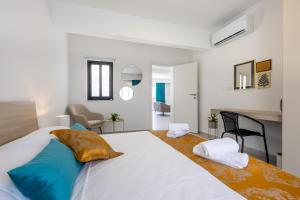 a bedroom with a large white bed with blue pillows at Stylish Side Seaview Penthouse By Quicktrips in St. Paul's Bay