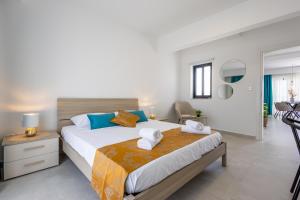 a bedroom with a large bed and a living room at Stylish Side Seaview Penthouse By Quicktrips in St. Paul's Bay
