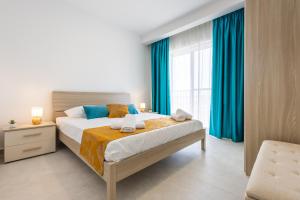 a bedroom with a bed and a large window at Stylish Side Seaview Penthouse By Quicktrips in St. Paul's Bay