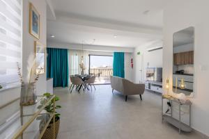 a living room with a table and a dining room at Stylish Side Seaview Penthouse By Quicktrips in St. Paul's Bay