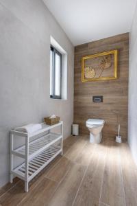 a bathroom with a toilet and a picture on the wall at Stylish Side Seaview Penthouse By Quicktrips in St. Paul's Bay +18 photos
