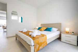 a bedroom with a bed with towels on it at Stylish Side Seaview Penthouse By Quicktrips in St. Paul's Bay
