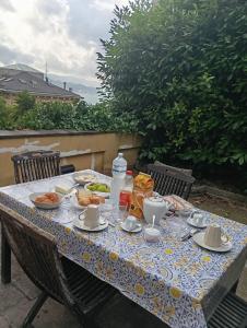 a table with plates of food on it at Small Luxury Bed & Breakfast in La Spezia