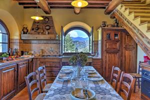 a kitchen with a long table and chairs in a room at LE MACINE 6, Emma Villas in Castel del Piano