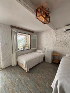 a bedroom with two beds and a window at Bum Alaçatı in Çeşme +25 photos