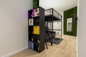 a room with a loft bed and a living room at Apartamento Río Turia 4 in Valencia