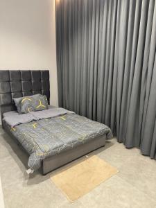 a bed in a room with black curtains at شاليهات نخبة الشرق in Riyadh +24 photos