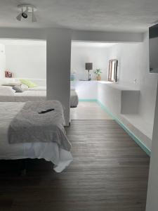 a bedroom with white walls and a bed in it at Villa Copacabana Family Loft in Jávea