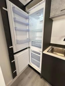 an empty refrigerator with its door open in a kitchen at Hull NEW Central Apartment 15 UNITS AVAILABLE in Hull