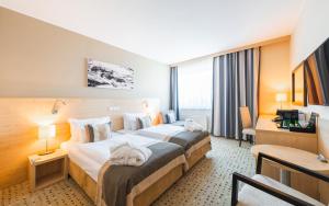 Postel nebo postele na pokoji v ubytování Aquapalace Hotel Prague