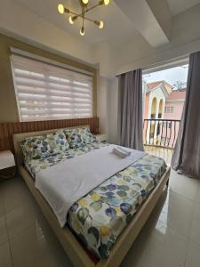 a bedroom with a large bed with a window at 3Bedroom unit in MinesView Park Free Parking in Baguio