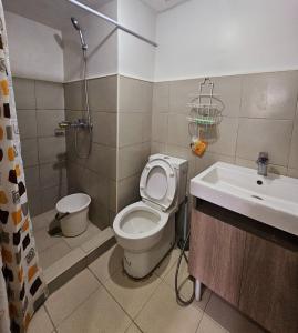 a bathroom with a toilet and a shower and a sink at 3Bedroom unit in MinesView Park Free Parking in Baguio +14 photos