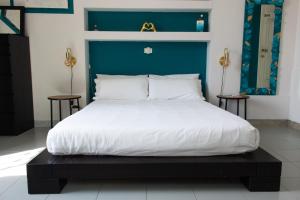 a bedroom with a large bed with a blue headboard at Caligo B&B Secret Garden Villa Room vicino alle Cinque Terre in La Spezia