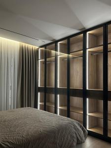 ティラナにあるClass Apartmentのベッドルーム(ベッド1台、棚付)