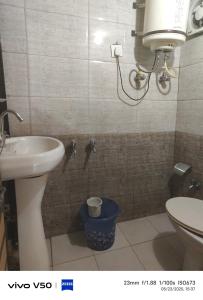 a bathroom with a sink and a toilet at Havemore luxury stays in Solan