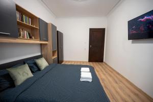 a bedroom with a bed and a tv on the wall at Martin's Treasure TOP CENTER in Sofia