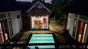 an aerial view of a house with a swimming pool at Oka Cottage in Nusa Penida