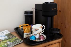 a tray with a coffee maker and a cup on a counter at Haverbrack Country House in Beetham +135 photos