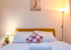a bedroom with a bed with two pillows at Monea Retreat a Modern 2bedroom and 2 bathroom apartment in Coventry in Coventry