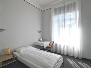 Ein Bett oder Betten in einem Zimmer der Unterkunft Hotel Monte Verità
