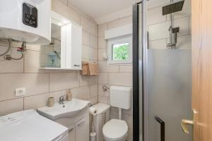 a small bathroom with a toilet and a sink at Lara apartment for two in Skrbčići +8 photos