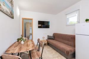 a living room with a couch and a table at Lara apartment for two in Skrbčići