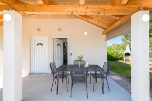 a patio with a black table and chairs at Lara apartment for two in Skrbčići