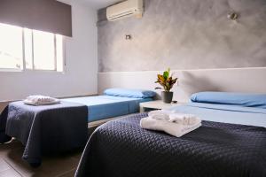 Postel nebo postele na pokoji v ubytování V Pension & Suites