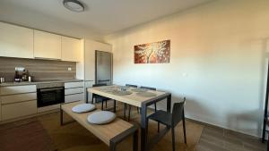 a kitchen with a table and some chairs and a table and a kitchen at Guesthouse Charitou in Áno Dhiakoptón