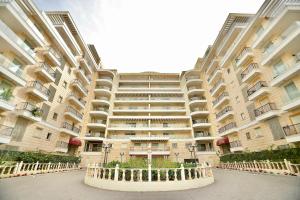 a large apartment building with a courtyard in front of it at אירופה בוטיק כנרת - דירת 4 חדרי שינה עם בריכה ונוף לכנרת in Tiberias